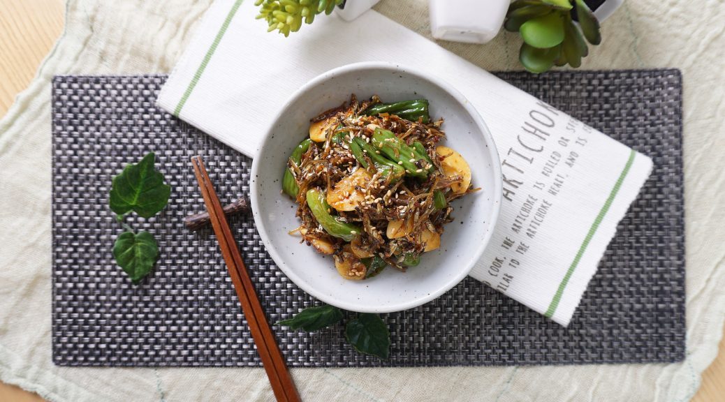 chopsticks resting next to bowl of food