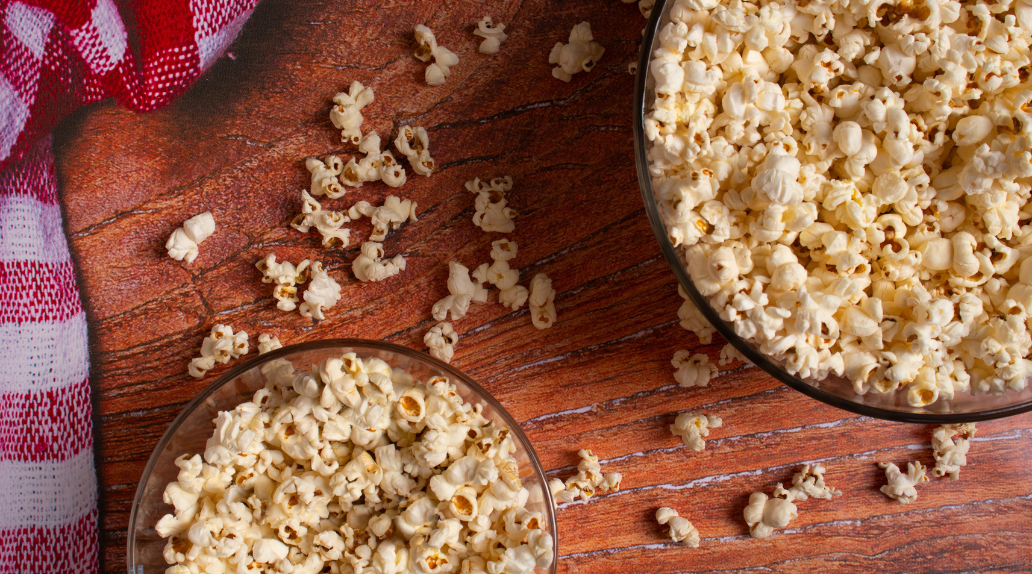 two bowls of popcorn with red and white checked towel