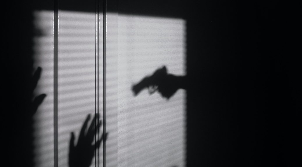 silhouette of gun in hand
